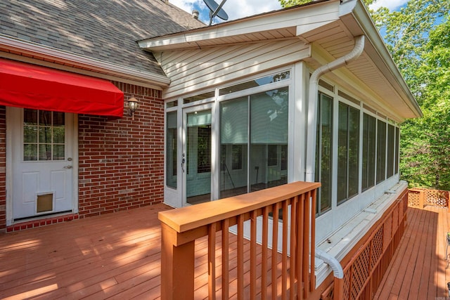 wooden deck with a sunroom