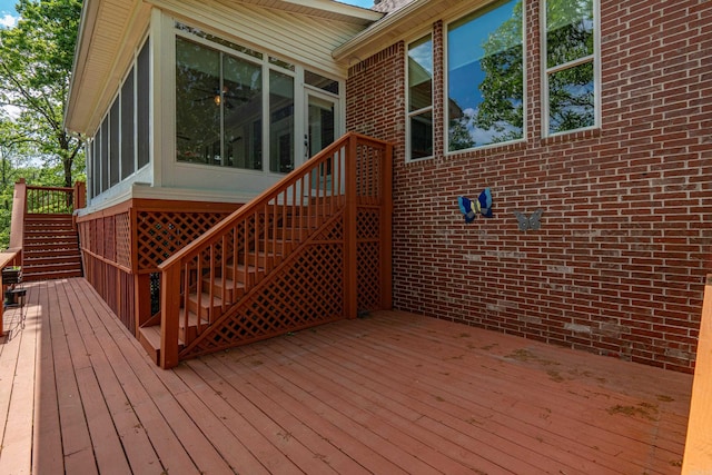 wooden terrace with a sunroom and stairway