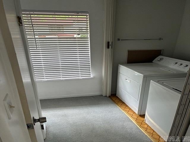 laundry room with laundry area, washer and dryer, and light carpet