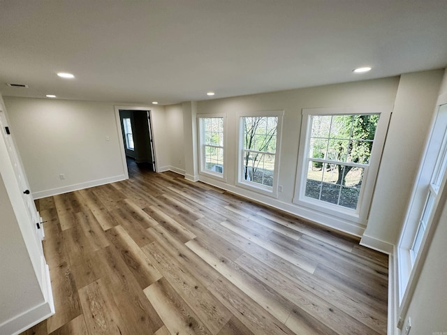 209 Goshen Ave, North Little Rock, AR 72116 - unfurnished room featuring visible vents, recessed lighting, baseboards, and wood finished floors