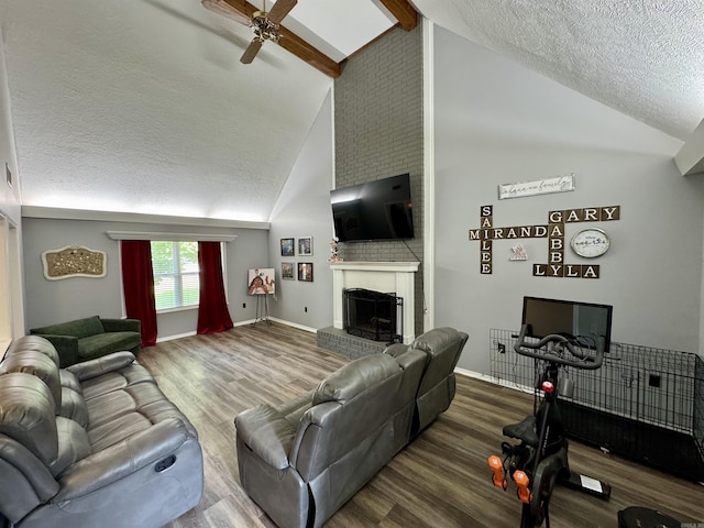 7 Franklin Cir, Searcy, AR 72143 - living room featuring wood finished floors, a fireplace, ceiling fan, high vaulted ceiling, and a textured ceiling