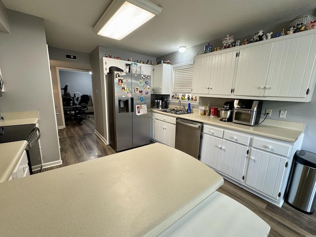 7 Franklin Cir, Searcy, AR 72143 - kitchen featuring baseboards, light countertops, white cabinets, dark wood finished floors, and stainless steel appliances
