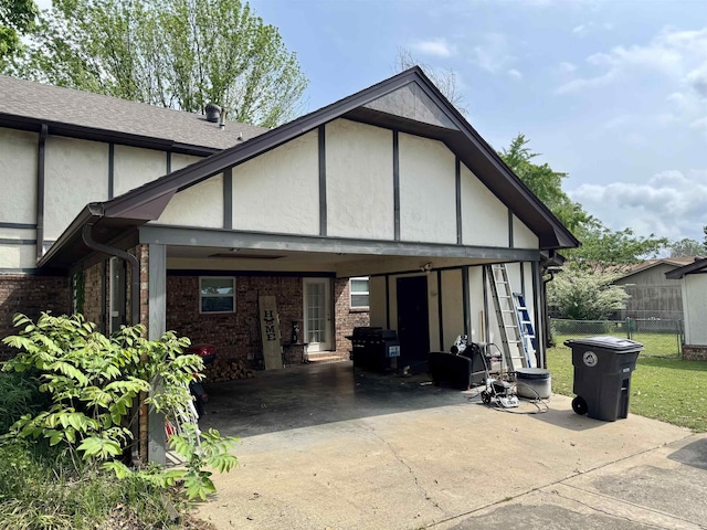 7 Franklin Cir, Searcy, AR 72143 - back of property with fence, brick siding, stucco siding, an attached carport, and concrete driveway