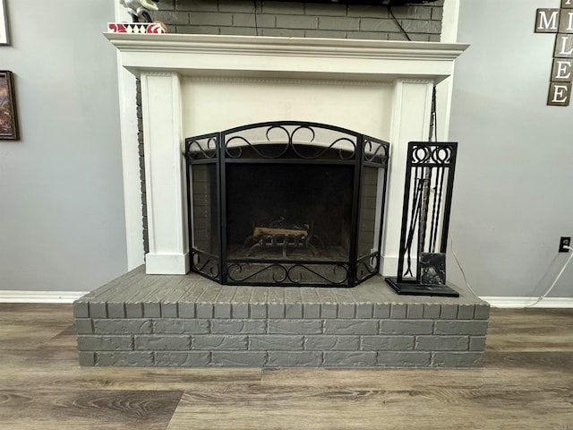 7 Franklin Cir, Searcy, AR 72143 - room details featuring a brick fireplace, baseboards, and wood finished floors