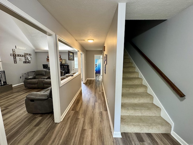 7 Franklin Cir, Searcy, AR 72143 - hall featuring baseboards, stairs, a textured ceiling, and dark wood-type flooring