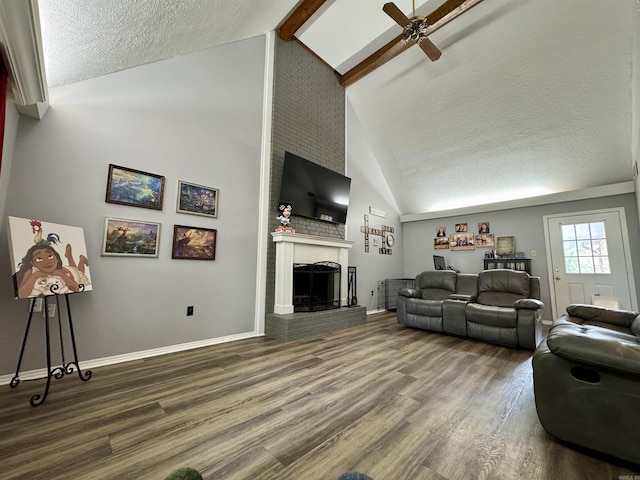 7 Franklin Cir, Searcy, AR 72143 - living area with ceiling fan, a fireplace, a textured ceiling, baseboards, and wood finished floors