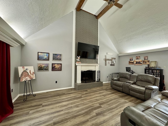 7 Franklin Cir, Searcy, AR 72143 - living area featuring a brick fireplace, a textured ceiling, wood finished floors, and lofted ceiling