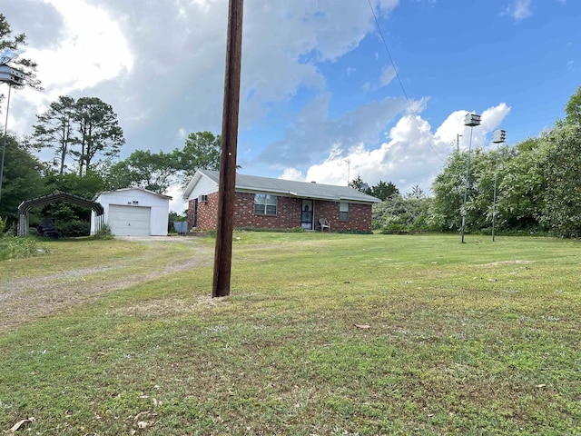view of yard featuring a garage and an outdoor structure