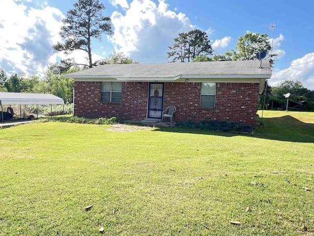 single story home with a carport, brick siding, and a front yard