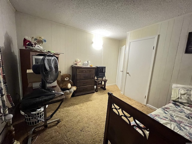 bedroom featuring light carpet and a textured ceiling