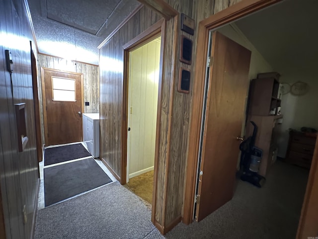 hallway featuring carpet flooring and washer / dryer