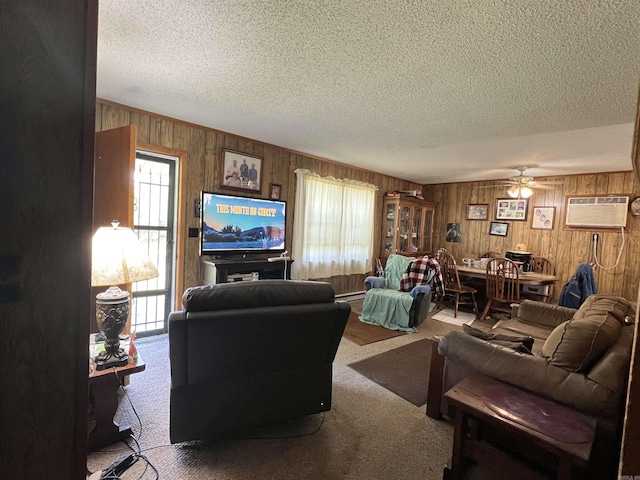 living area featuring a wall mounted air conditioner, wooden walls, and a wealth of natural light