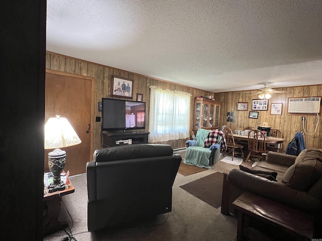 carpeted living room featuring a wall mounted air conditioner, ceiling fan, wooden walls, a textured ceiling, and a baseboard radiator