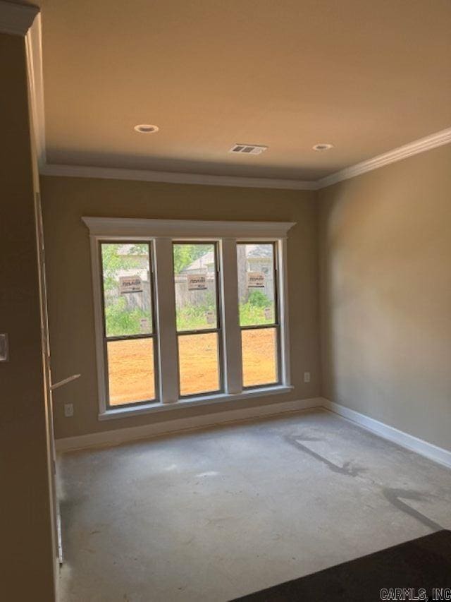 spare room featuring baseboards, recessed lighting, and crown molding