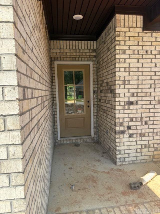 property entrance with brick siding
