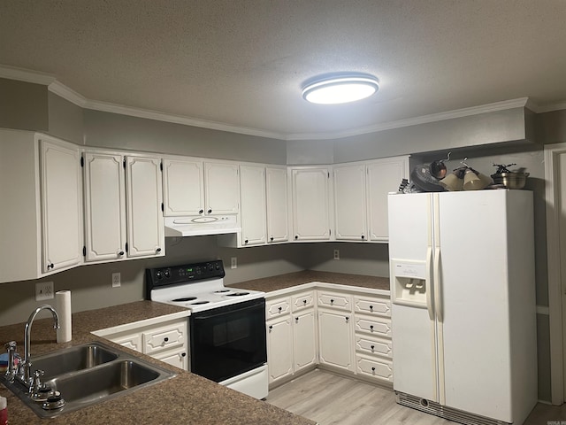 kitchen with dark countertops, white appliances, light wood-type flooring, under cabinet range hood, and a sink