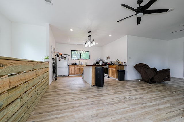 kitchen featuring light wood-type flooring, freestanding refrigerator, ceiling fan with notable chandelier, open floor plan, and recessed lighting