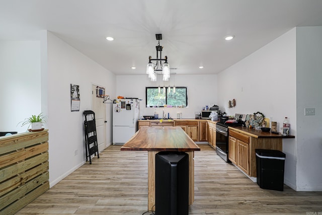 kitchen featuring appliances with stainless steel finishes, light wood-style flooring, recessed lighting, and butcher block countertops