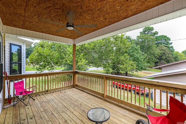 wooden deck with a ceiling fan