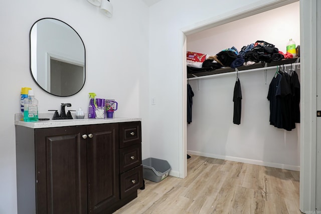 spacious closet featuring light wood-style flooring