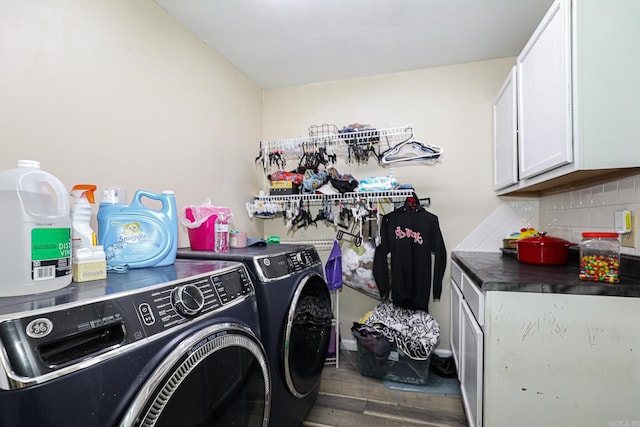 laundry room featuring cabinet space, independent washer and dryer, and wood finished floors