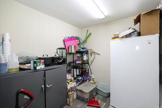 interior space with freestanding refrigerator and wood finished floors