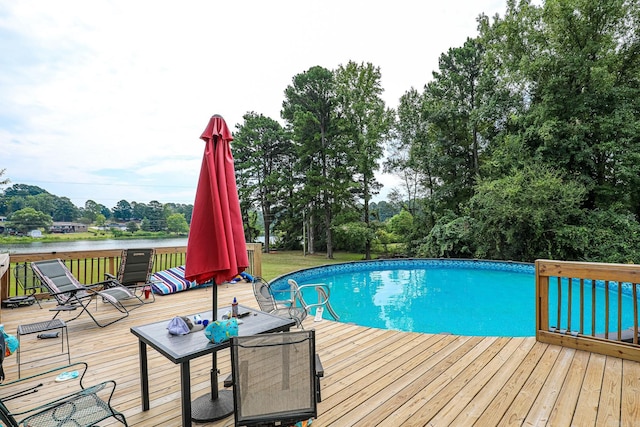 outdoor pool featuring a deck with water view