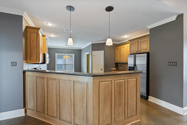 kitchen with baseboards, crown molding, appliances with stainless steel finishes, and backsplash