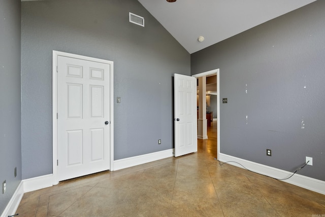unfurnished bedroom with high vaulted ceiling, baseboards, and visible vents