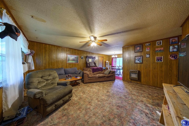 3009 N Main St, Mount Pleasant, AR 72651 - carpeted living room with heating unit, ceiling fan with notable chandelier, wood walls, and a textured ceiling