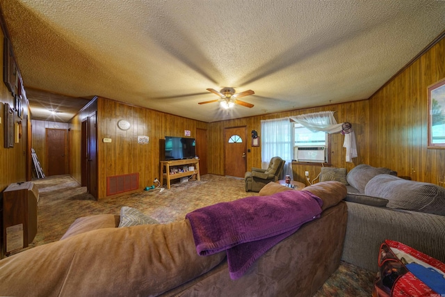 3009 N Main St, Mount Pleasant, AR 72651 - living room with ceiling fan, a textured ceiling, visible vents, wood walls, and cooling unit