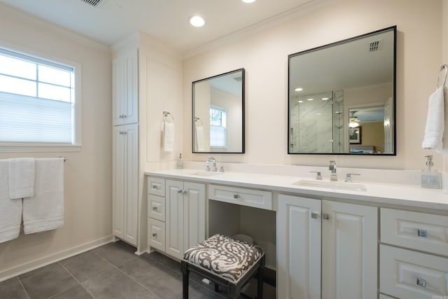 bathroom with tile patterned floors, ornamental molding, and a sink