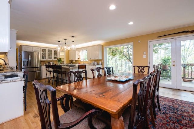 dining area with french doors, recessed lighting, light wood-style flooring, and crown molding
