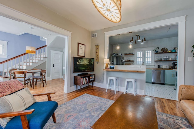 316 W 22nd, Little Rock, AR 72206 - living room with stairs, baseboards, visible vents, and light wood-style flooring
