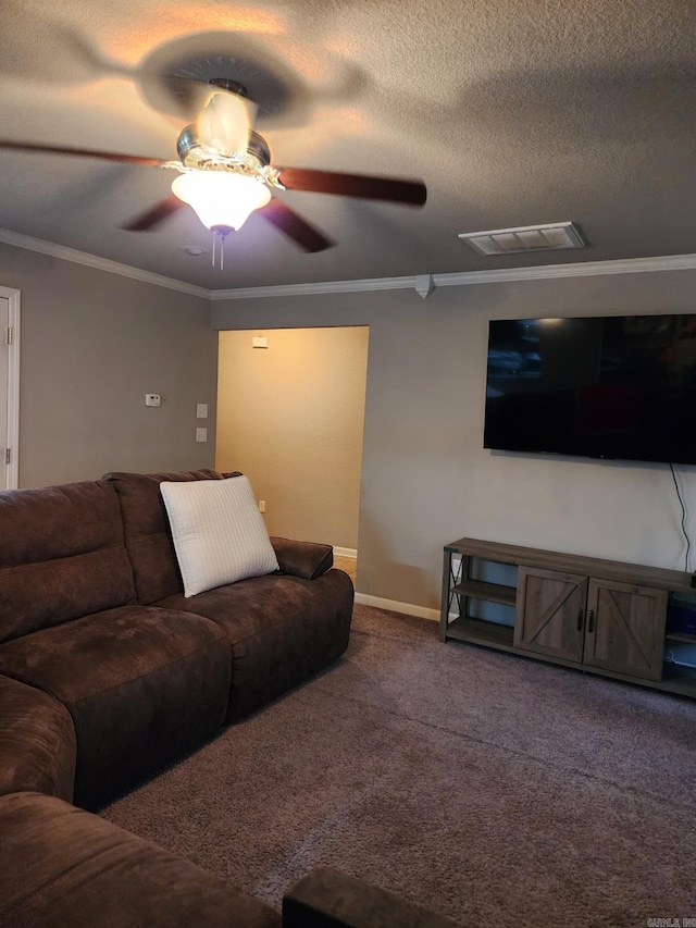 living room featuring a ceiling fan, visible vents, baseboards, ornamental molding, and carpet
