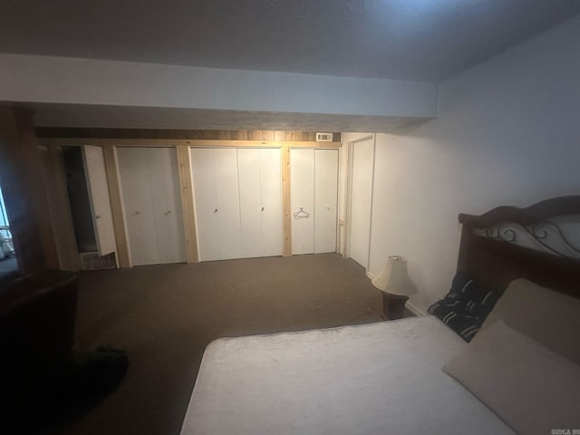 carpeted bedroom featuring visible vents