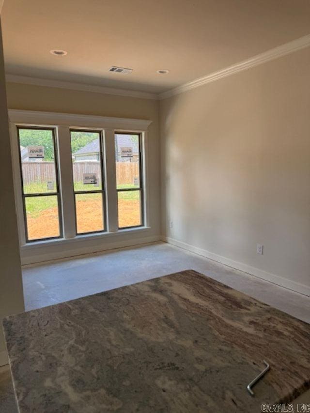 empty room featuring crown molding, baseboards, recessed lighting, and visible vents
