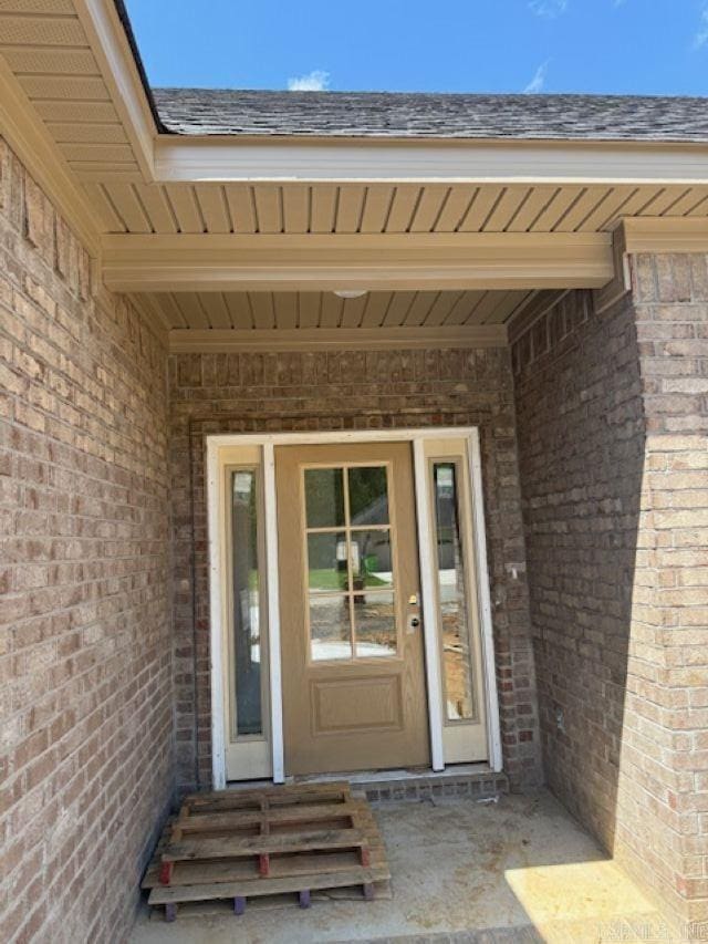 property entrance featuring brick siding