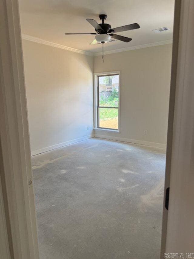 spare room featuring baseboards, visible vents, ornamental molding, and ceiling fan