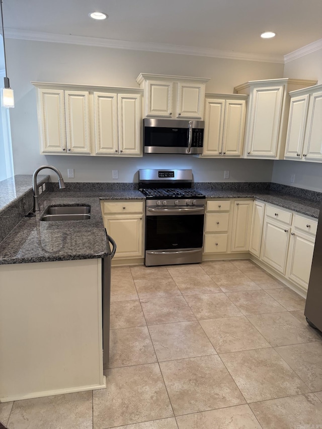 kitchen featuring a sink, dark stone counters, ornamental molding, stainless steel appliances, and recessed lighting