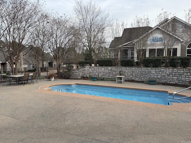 view of swimming pool featuring a fenced in pool, fence, and a patio
