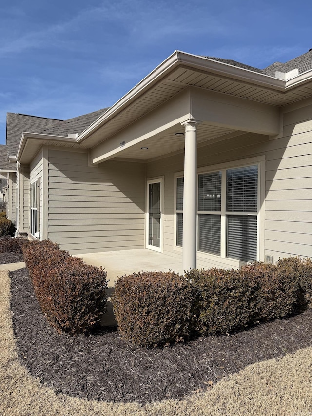 view of home's exterior with roof with shingles
