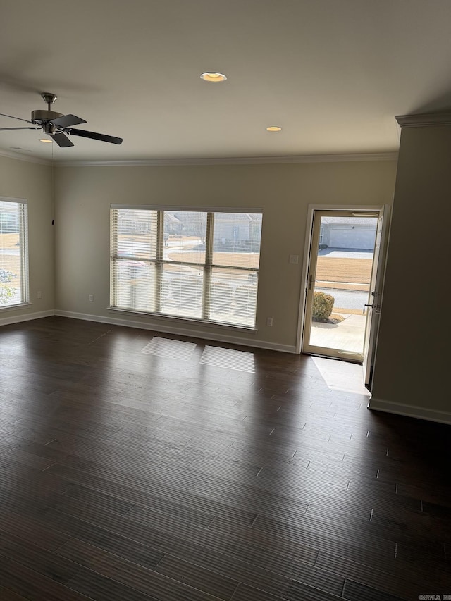 unfurnished room featuring crown molding, baseboards, ceiling fan, and dark wood-style floors