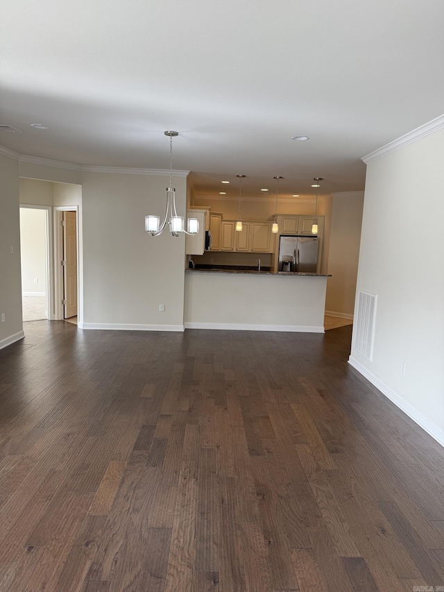 unfurnished living room featuring baseboards, ornamental molding, dark wood finished floors, and a chandelier