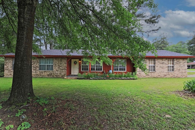 single story home with brick siding and a front yard