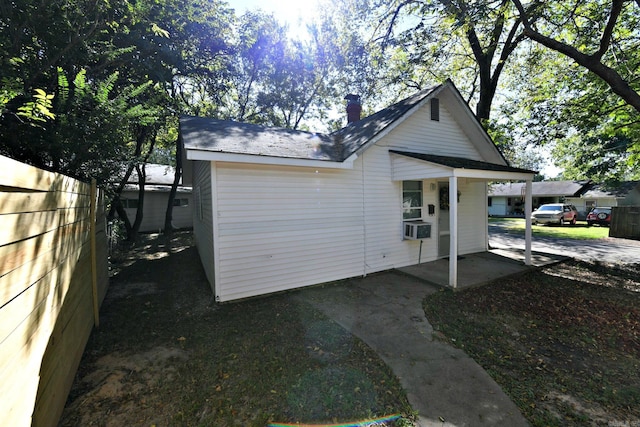 exterior space featuring fence and cooling unit