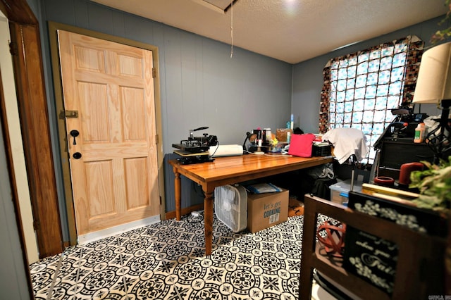 office space featuring a textured ceiling, tile patterned floors, and attic access