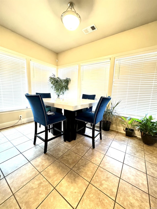 dining space featuring light tile patterned floors and visible vents