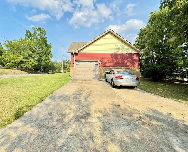 view of side of home with an attached garage, brick siding, a yard, and driveway