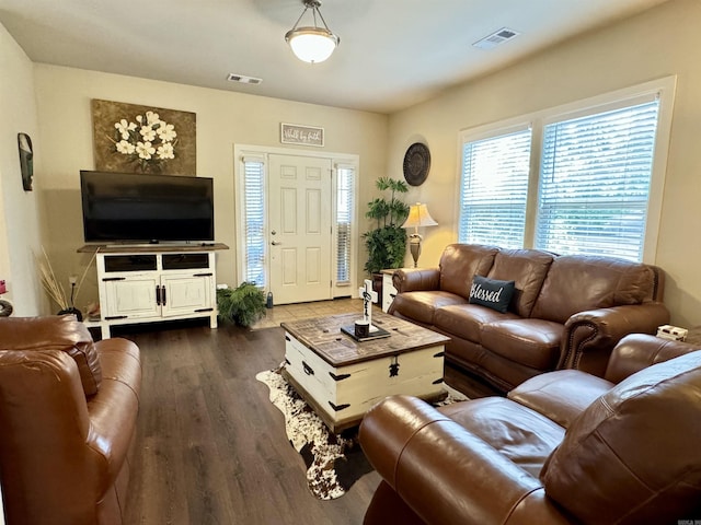 living room with visible vents and dark wood-style floors